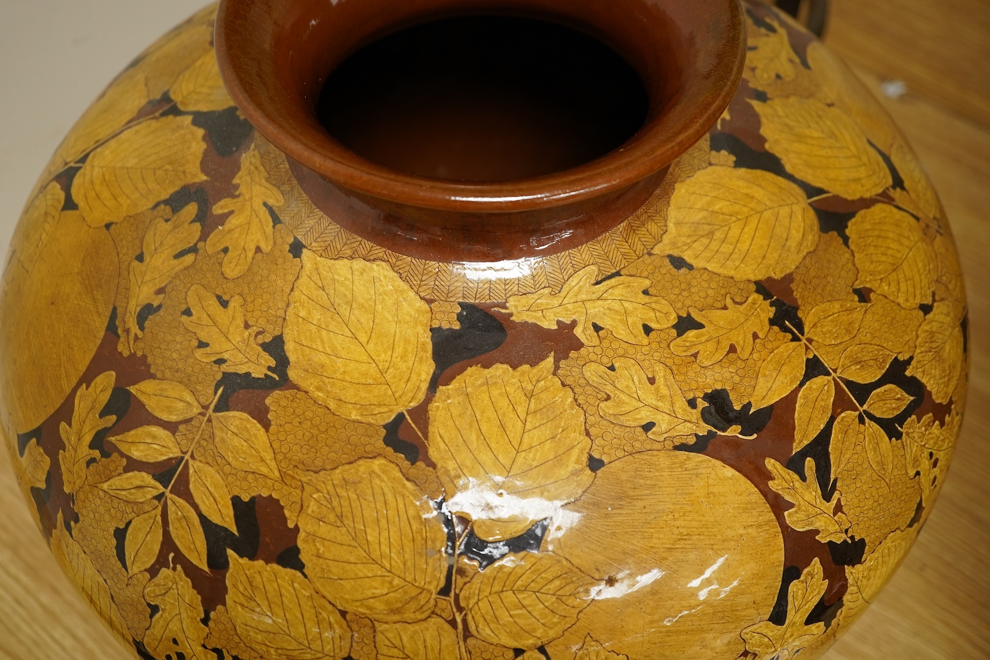 A large terracotta foliaiate decorated vase, 38cm high
